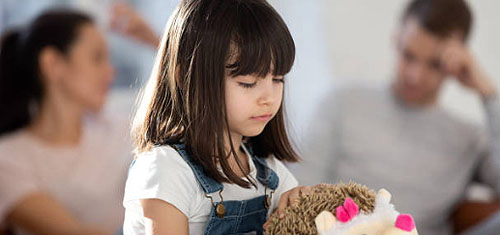 A young girl holding a toy