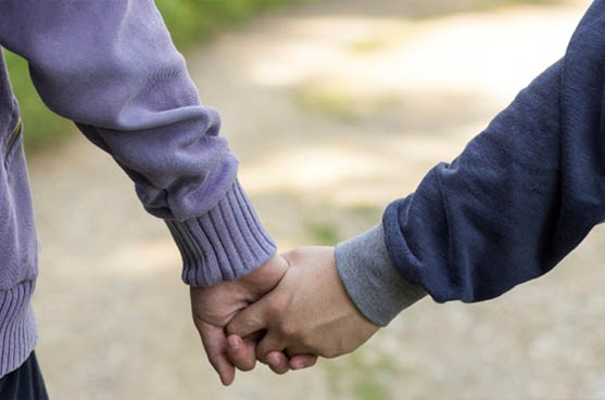 two people holding hands