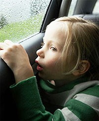 Little girl staring out the car window 